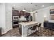 Well-equipped kitchen with a large island, dark cabinets, and pendant lighting, ready for culinary adventures at 821 Ethereow Ct, Lawrenceville, GA 30046