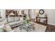 Spacious living room boasts a comfortable sectional sofa, a stylish coffee table, and hardwood floors at 821 Ethereow Ct, Lawrenceville, GA 30046