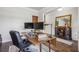 Home office with a wooden desk, two monitors, and decor with hardwood floors and lots of natural light at 821 Ethereow Ct, Lawrenceville, GA 30046