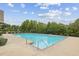 Inviting community pool with clear blue water, surrounded by lush greenery, perfect for recreation at 821 Ethereow Ct, Lawrenceville, GA 30046