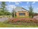 Community sign with lush landscaping and colorful flowers at 821 Ethereow Ct, Lawrenceville, GA 30046