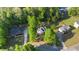 Stunning aerial view of the property nestled among mature trees with a long driveway at 120 Julia Ct, Fayetteville, GA 30214
