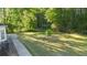 A spacious backyard with lush green grass and plenty of shade trees at 120 Julia Ct, Fayetteville, GA 30214