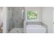 Bathroom featuring tiled shower, a soaking tub and window at 120 Julia Ct, Fayetteville, GA 30214