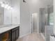 Modern bathroom featuring dual sinks, granite counters, and a glass enclosed shower at 120 Julia Ct, Fayetteville, GA 30214