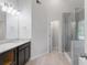 Bathroom featuring a glass enclosed shower, double vanity and sleek lighting fixtures at 120 Julia Ct, Fayetteville, GA 30214