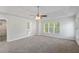 Bright bedroom featuring a trey ceiling, a ceiling fan, and an ensuite bathroom entrance at 120 Julia Ct, Fayetteville, GA 30214