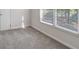 Bedroom showcasing natural light from the windows and plush gray carpeting at 120 Julia Ct, Fayetteville, GA 30214