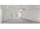 A large primary bedroom with ceiling fan and view at 120 Julia Ct, Fayetteville, GA 30214