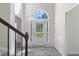 The foyer boasts a front door with sidelights and wood-look flooring at 120 Julia Ct, Fayetteville, GA 30214