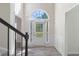 Light-filled foyer featuring a striking arched window and stylish flooring at 120 Julia Ct, Fayetteville, GA 30214