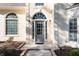Close up view of a traditional home featuring sidelights, transom, and a gray front door at 120 Julia Ct, Fayetteville, GA 30214