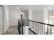 Hallway with carpet and iron railing, leading to bedrooms at 120 Julia Ct, Fayetteville, GA 30214