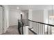 Upstairs hallway with access to bedrooms; dark metal railings and neutral carpet at 120 Julia Ct, Fayetteville, GA 30214