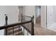 View of hallway from staircase; carpeting, metal railing at 120 Julia Ct, Fayetteville, GA 30214