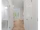 Hallway with updated floors leading to kitchen and a half bath at 120 Julia Ct, Fayetteville, GA 30214