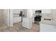 Modern kitchen with white cabinets, granite countertops, and stainless steel appliances at 120 Julia Ct, Fayetteville, GA 30214