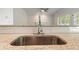 Granite counters and stainless steel sink and faucet in updated kitchen at 120 Julia Ct, Fayetteville, GA 30214