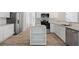 Charming kitchen showcasing stainless steel appliances, granite countertops, and a center island with open shelves at 120 Julia Ct, Fayetteville, GA 30214