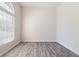 Minimalist room featuring wood floors, white walls, and a large window at 120 Julia Ct, Fayetteville, GA 30214