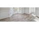 Bright living room featuring large windows and light wood-look flooring at 120 Julia Ct, Fayetteville, GA 30214