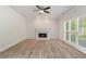 Open living room with a fireplace and large windows bringing in natural light at 120 Julia Ct, Fayetteville, GA 30214