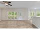 Open-plan living area with hardwood floors, large windows, and view of the backyard at 120 Julia Ct, Fayetteville, GA 30214