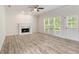 Living room with fireplace, hardwood floors, and a large window with lots of natural light at 120 Julia Ct, Fayetteville, GA 30214