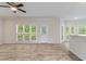 Open floorplan with light gray floors, many windows, and a breakfast bar at 120 Julia Ct, Fayetteville, GA 30214