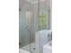 Bathroom featuring a tiled shower with glass enclosure and modern fixtures at 120 Julia Ct, Fayetteville, GA 30214