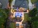 Aerial view showcasing the expansive backyard with a pool, outdoor kitchen, and lush landscaping at 2439 Huntington Park Nw Dr, Acworth, GA 30101