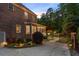 Backyard view showing a screened porch, a gazebo, lush landscaping, and garden lights at 2439 Huntington Park Nw Dr, Acworth, GA 30101
