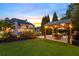 Expansive backyard with an outdoor kitchen, lush green lawn, and luxurious in-ground swimming pool at 2439 Huntington Park Nw Dr, Acworth, GA 30101