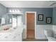 Stylishly remodeled bathroom featuring wainscotting and a walk-in closet at 2439 Huntington Park Nw Dr, Acworth, GA 30101