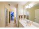 Bathroom featuring a large mirror and a white sink, illuminated by modern vanity lighting at 2439 Huntington Park Nw Dr, Acworth, GA 30101