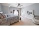 Spacious bedroom with light gray walls and a ceiling fan with neutral decor and large windows at 2439 Huntington Park Nw Dr, Acworth, GA 30101