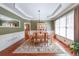Elegant dining room with hardwood floors, crown molding, and large windows creating a warm atmosphere at 2439 Huntington Park Nw Dr, Acworth, GA 30101