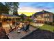 Relaxing fire pit area with Adirondack chairs, complemented by outdoor kitchen and backyard pool views at 2439 Huntington Park Nw Dr, Acworth, GA 30101