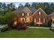 Charming brick home with manicured front yard and lush landscaping, creating a welcoming curb appeal at 2439 Huntington Park Nw Dr, Acworth, GA 30101