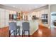 Bright kitchen with an island with chairs, custom cabinetry, granite counters, and stainless appliances at 2439 Huntington Park Nw Dr, Acworth, GA 30101