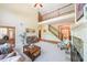 Open-concept living room with a cozy fireplace, staircase and large windows that flood the space with natural light at 2439 Huntington Park Nw Dr, Acworth, GA 30101