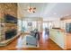 Bright living room featuring a stone fireplace and hardwood flooring at 2439 Huntington Park Nw Dr, Acworth, GA 30101