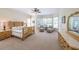 Bright main bedroom with large windows, a king bed, and sitting area at 2439 Huntington Park Nw Dr, Acworth, GA 30101