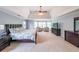 Spacious primary bedroom featuring tray ceilings, sitting area, and large windows offering plenty of natural light at 2439 Huntington Park Nw Dr, Acworth, GA 30101