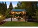 Inviting outdoor kitchen and dining area, perfect for entertaining amidst a serene, wooded backdrop at 2439 Huntington Park Nw Dr, Acworth, GA 30101