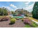 Beautiful backyard oasis featuring a sparkling in-ground pool, manicured landscaping, and a stone patio at 2439 Huntington Park Nw Dr, Acworth, GA 30101