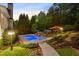 Lush landscaped pool featuring a garden retreat, a gazebo, lounge chairs, and stone steps at 2439 Huntington Park Nw Dr, Acworth, GA 30101