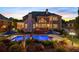Serene backyard featuring a stunning in-ground pool, deck, and lush landscaping at dusk at 2439 Huntington Park Nw Dr, Acworth, GA 30101