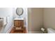 Cozy powder room with a wood vanity and framed mirror at 2439 Huntington Park Nw Dr, Acworth, GA 30101