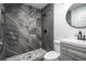 Bathroom boasts a stylish tiled walk-in shower with pebble flooring and a modern vanity at 5101 Rockbridge Rd, Stone Mountain, GA 30088